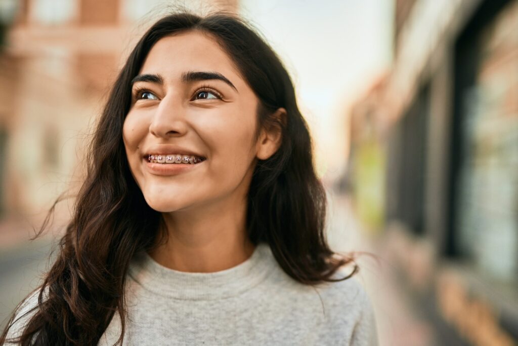 Closeup of woman smiling with braces